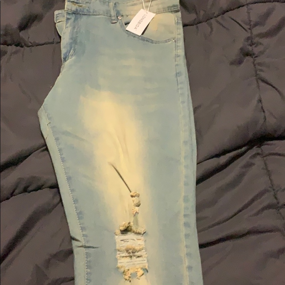 Stylish man light blue blue jeans with Rips